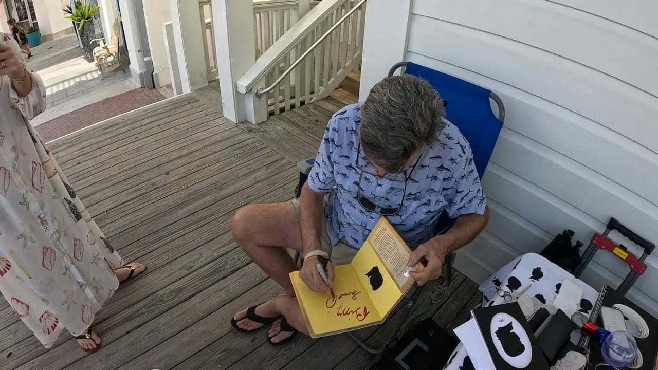 Clay Rice signing one of his books